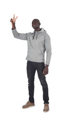  man showing victory sign with fingers, look up on white background - 788736979