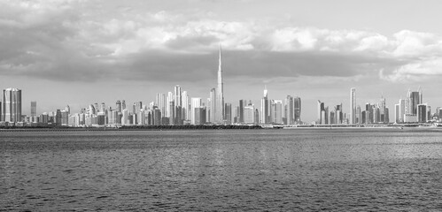 view of Dubai Downtown cityline from Dubai Creek Canal, black and white
