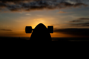 silhouette of a longboard