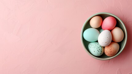   A bowl holds various colored eggs on a pink, speckled surface The eggs' tops and bottoms bear speckles