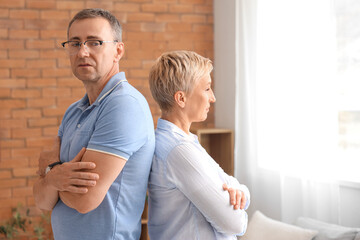 Offended mature couple after quarrel at home