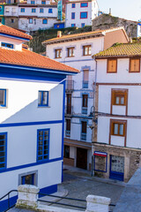 Warm sunlight highlights cultural heritage of Cudillero: charming coastal town in northern Spain.