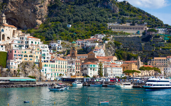 Beautiful Amalfi on hills leading down to coast, azure sea in Campania, Italy