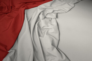 waving national flag of indonesia on a gray background.