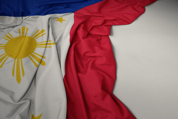 waving national flag of philippines on a gray background.