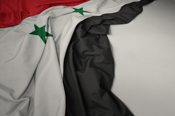 waving national flag of syria on a gray background.
