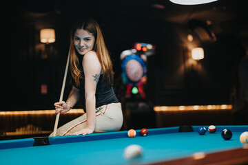 A young female enthusiast enjoys a game of billiards, wielding her cue stick with ease and...