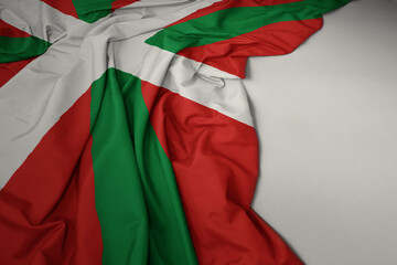 waving national flag of basque country on a gray background.