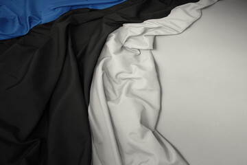 waving national flag of estonia on a gray background.