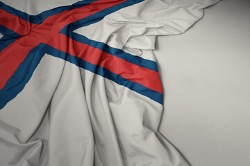 waving national flag of faroe islands on a gray background.