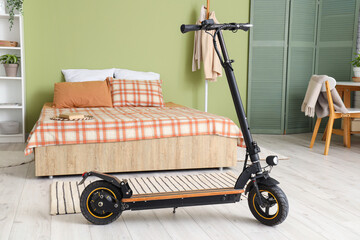 Electric scooter in interior of stylish bedroom