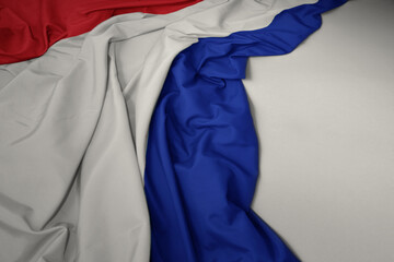 waving national flag of netherlands on a gray background.