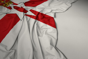 waving national flag of northern ireland on a gray background.