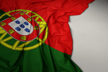 waving national flag of portugal on a gray background.