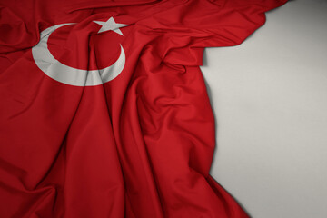 waving national flag of turkey on a gray background.
