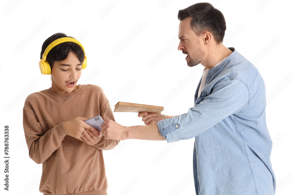 Wall mural Angry father with book taking mobile phone away from his teenage son on white background. Family problem concept