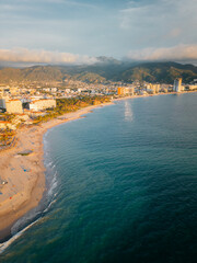 Aerial view from the Hotel Zone over turquoise ocean water looking towards central Puerto Vallarta.