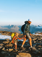 Family on active vacation father and child climbing mountains traveling together in Norway summer adventure trip healthy lifestyle outdoor dad with daughter trekking, eco tourism