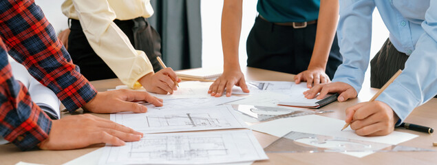 Skilled architect engineer team discuss about architectural project while project manager using...