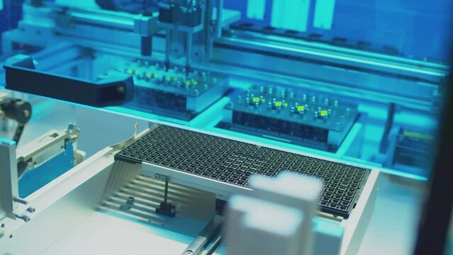 modern industrial equipment.industrial robot assembles an electronic board.technological process of assembling a complex technical product .close-up.