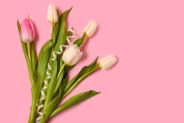 Beautiful tulips with ribbon on pink background. International Women's Day