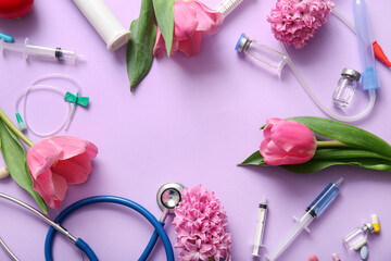 Frame made of stethoscope with syringes, ampules and flowers for International Nurses Day on lilac background