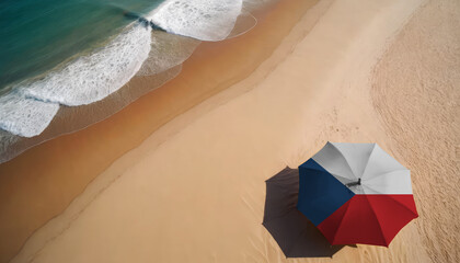 An aerial vista of a sandy beach with gentle ocean waves, featuring a beach umbrella adorned with the Czech flag. Ideal for Czech tourists seeking seaside relaxation