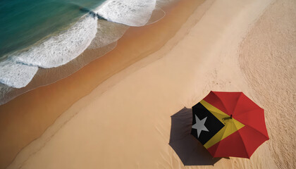 An aerial vista of a sandy beach with gentle ocean waves, featuring a beach umbrella adorned with the East Timor flag. Ideal for East Timor tourists seeking seaside relaxation