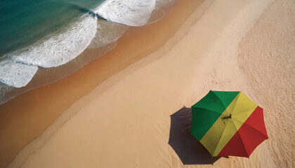 An aerial vista of a sandy beach with gentle ocean waves, featuring a beach umbrella adorned with the Republic of the Congo flag. Ideal for Republic of the Congo tourists seeking seaside relaxation