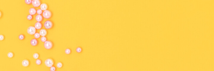 Banner with imitation pearl beads on a yellow background. Place for text.