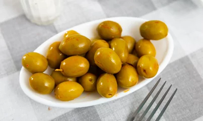 Foto op Plexiglas Portion of whole marinated olives with pits served on plate. © JackF