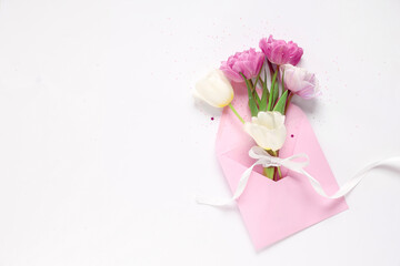 Envelope with beautiful tulips on white background. Mother's Day celebration