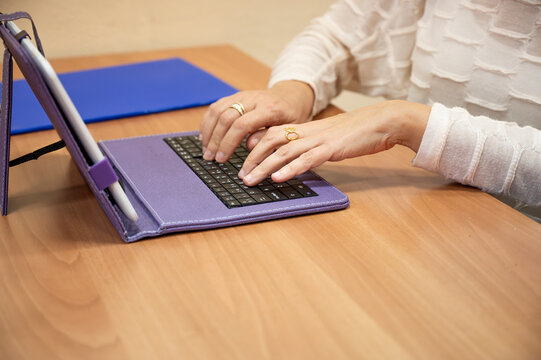 Close-Up of Hands Typing on Tablet Keyboard