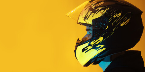man in a helmet on a yellow background , copy space