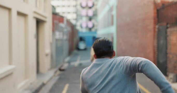 Man, thief and running with phone in city street, road or alley for robbery, crime or stolen property. Rear view of male person getting robbed with smartphone in hallway or passage in an urban town