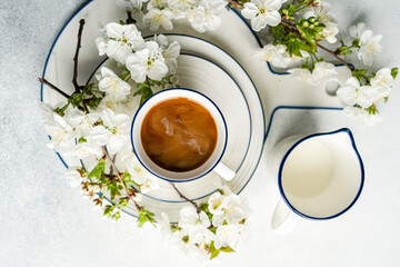Coffee cup with spring blossom on a white background