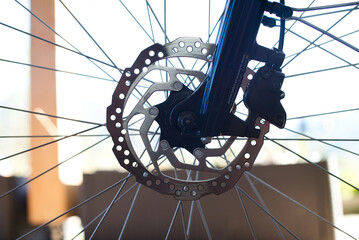 Close-up of E-Bike Front Wheel with Stainless Steel Brake Disc and Caliper