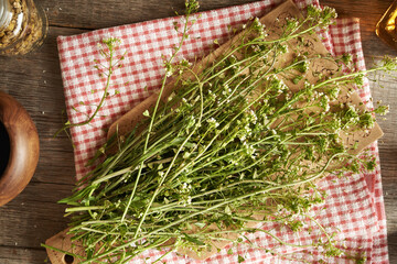 Blooming shepherd's purse herb on a table - ingredient for tincture - 788799909