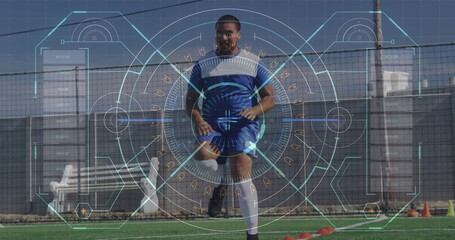 A biracial athlete wearing blue and white kit is training on a soccer field