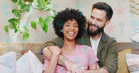 Diverse couple sitting together, biracial woman and Caucasian man laughing