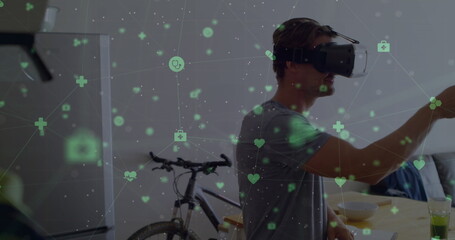 Caucasian male wearing virtual reality headset, reaching out