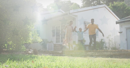 African American family walking outside, holding hands