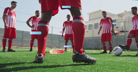 Group of friends wearing red and white soccer uniforms standing on field