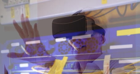 Caucasian senior male wearing virtual reality headset, reaching out