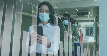 Diverse team analyzing data on glass wall, wearing masks