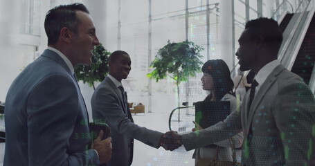 Diverse group of professionals greeting each other in office - 788804716