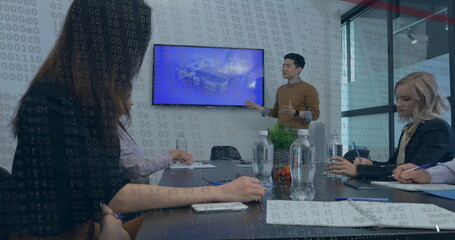 A diverse team is having meeting, with a man presenting on a screen - 788804723