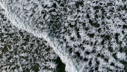 Beautiful texture of big power dark ocean waves with white wash. Aerial top view footage of...