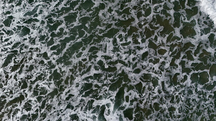Beautiful texture of big power dark ocean waves with white wash. Aerial top view footage of...