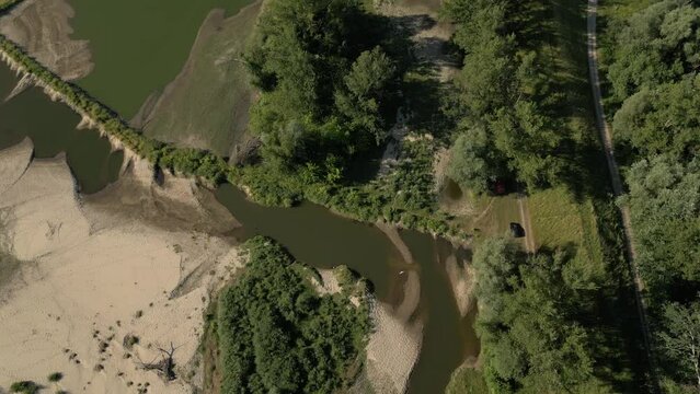 Aerial footage of Vistula River and vast green fields on a sunny day in Solec nad Wisla town, Poland